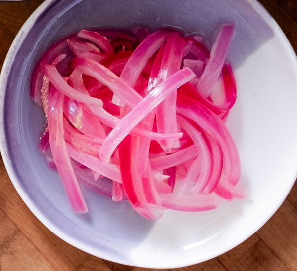 Pickled red onions on small plate