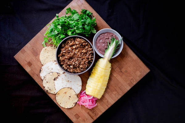 Plant-based al pastor tacos ingredients on cutting board